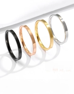 Detailed display of four 316L titanium steel rings in black, gold, rose gold and silver