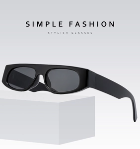 Detailed view of black rectangle sunglasses placed on a minimalist white geometric stand