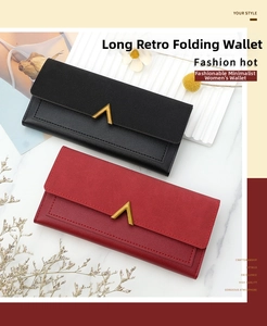 Close-up of vintage long wallet featuring a gold V-shaped buckle and textured faux leather