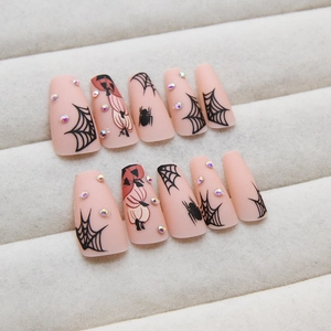 Halloween matte pink press-on nails with spider web, pumpkin designs and rhinestones