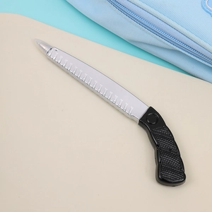 Macro view of novelty folding saw shaped ballpoint pen with black handle and silver nib