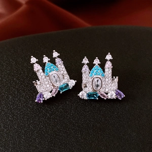 Detailed macro shot of a castle earring with colorful gemstones on black textured fabric