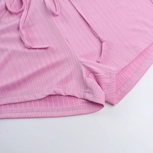 Detail of pink ribbed knit shorts showing fabric texture and adjustable drawstring waist