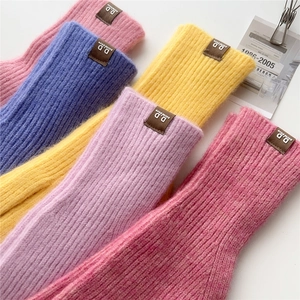 Chunky knit wool gloves in vibrant colors with premium leather labels for winter warmth