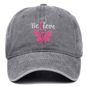 Detail of embroidered Believe text and pink ribbon butterfly on washed denim baseball cap