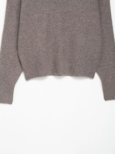 Close-up of ribbed cuffs and hem on a coffee-colored V-neck knit sweater for women