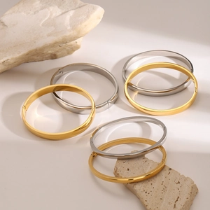 Polished gold and silver stainless steel square clasp bracelets on natural stones