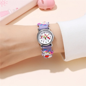 Close-up of kids purple silicone watch with 3D unicorn decor on a child's wrist