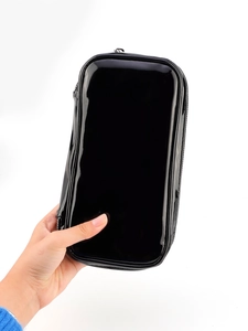 Detail view of large black shiny PU leather makeup brush bag with zipper closure