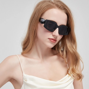 Detail of trendy black thick frame rectangular sunglasses on a female model with UV protection