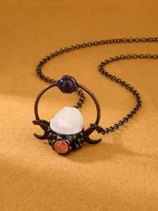 Close-up of bronze triple moon necklace with white crystal druzy and amethyst stones