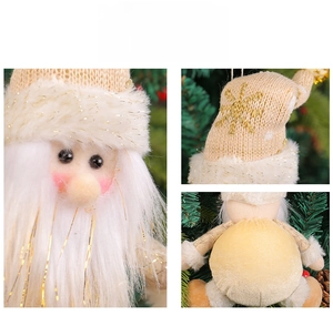 Detail of Santa Claus plush ornament with beige knit fabric and golden snowflake embroidery