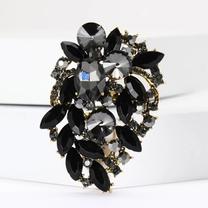 Detailed macro view of vintage gold alloy brooch with black marquise crystals