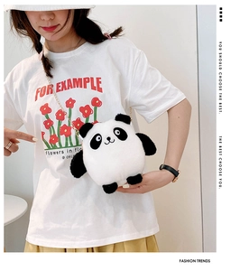 Close-up of cute panda plush crossbody bag with a golden chain strap on a model