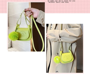 Detail of neon green mini crossbody bag featuring a plush charm and embossed character design