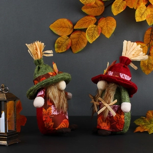 Set of two decorative fall harvest gnomes with autumn leaves and mini pumpkin decorations
