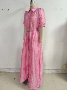 Detail of pink floral jacquard dress with elegant silk sheen and matching belt