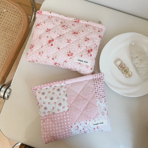 Close-up of pink floral quilted cotton cosmetic bags with zipper and simple wish label