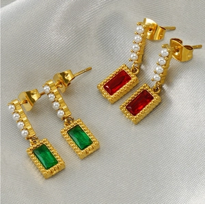 Detail of square-cut emerald and ruby earrings with gold plating and white pearls