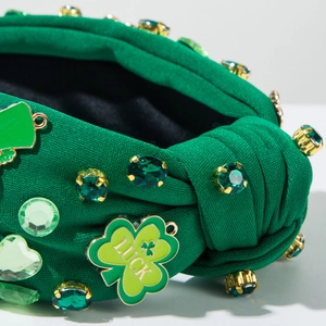 Detail of green knit headband with rhinestones and Luck clover metal charm for St. Patrick's