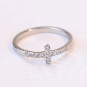 Macro shot of 7mm stainless steel ring with horizontal cross and sparkling zircon inlay