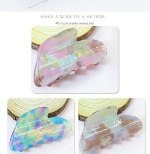Set of three colorful heart-shaped hair claws with pearlescent and marble textures