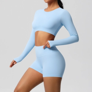 Light blue two-piece yoga set with long sleeve crop top and high waist sports shorts