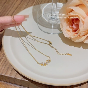 Detailed view of sparkling star pendant necklace with cubic zirconia on gold chain