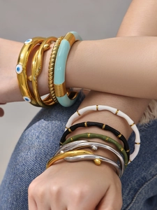 Vista dettagliata dei bracciali sovrapposti in acciaio inossidabile smaltato con occhio greco