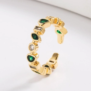 Close-up of 18K gold-plated ring featuring green pear-cut stones and white cubic zirconia
