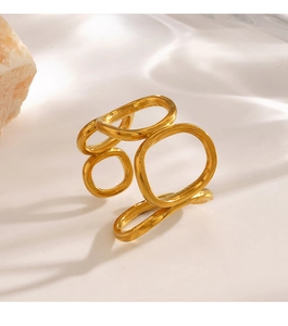 Macro view of geometric cutout oval ring in gold finish on natural stone background