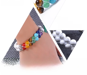 Macro detail of natural chakra gemstones and white howlite beads on double-layer bracelets