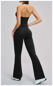 Detail view of the back showing high-waisted flared yoga pants and halter neck sports top