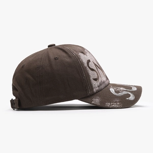 Brown distressed cotton baseball cap with white graffiti lettering and worn-out brim details