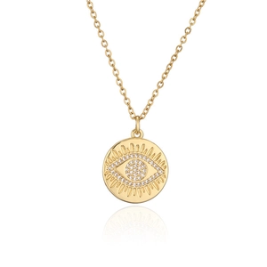 Macro view of gold-plated geometric disc necklace with zircon-set evil eye pendant
