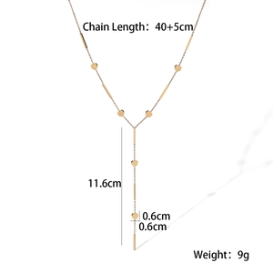 Detailed view of gold 18K plated Y-necklace with heart and geometric bar pendants