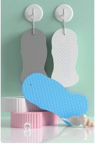 Detail showing fish-scale textured 3D bath sponges with hanging ropes in various pastel colors