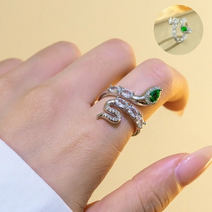 Detail of emerald green snake ring with zircon stones on silver adjustable band