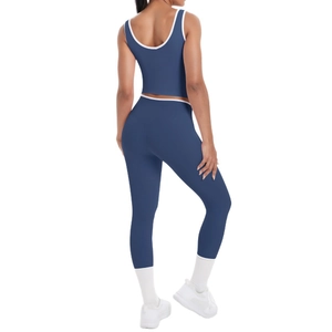 Navy blue two-piece yoga set with white contrast trim and high waist leggings
