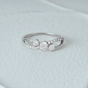 Macro shot of an elegant S925 sterling silver ring featuring a three-stone diamond design