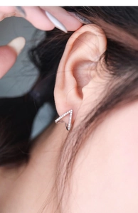 Close-up of S925 sterling silver V-shape stud earrings with shimmering zircon stones