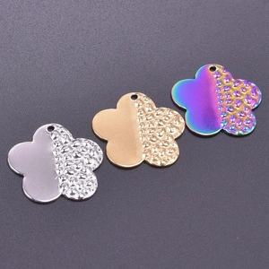 Three five-petal flower charms in gold, silver, and rainbow finish with hammered texture