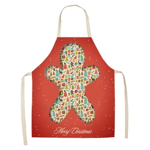 Detail of red Christmas apron with gingerbread man cutout and festive holiday patterns