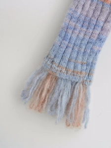 Close-up of blue and orange-pink striped knit scarf featuring fringe tassel details