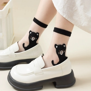 Detailed view of white crystal sheer socks featuring cute black cat embroidery patterns
