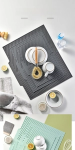 Macro detail of silicone drying mat with diagonal drainage ridges and hanging hole