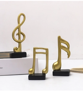 Three-piece gold music note decor set featuring treble clef and quavers on black bases