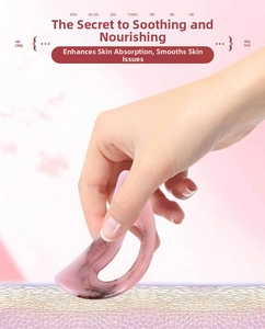 Pink translucent resin massage tool showing ergonomic curve for facial and body lifting
