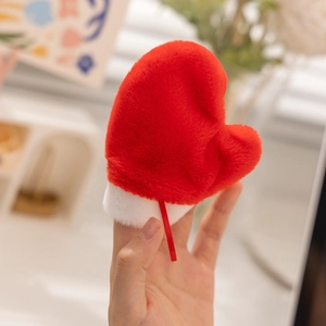 Detailed view of red plush heart ornament with white trim and ribbon for holiday decor
