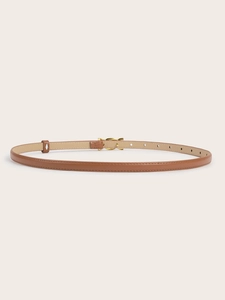 Detailed view of a slim brown faux leather belt with a polished golden metal buckle